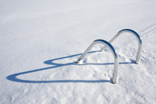 How To Use an Air Compressor to blow out your pool lines. Frozen snow covered pool with ladder sticking out.